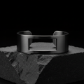 LUMEN Void Cuff Bracelet brushed gunmetal on dark stone surface