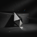 LUMEN Prism Pendant geometric silver necklace on dark surface